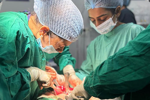 Surgeons in scrubs operating in the modular OT